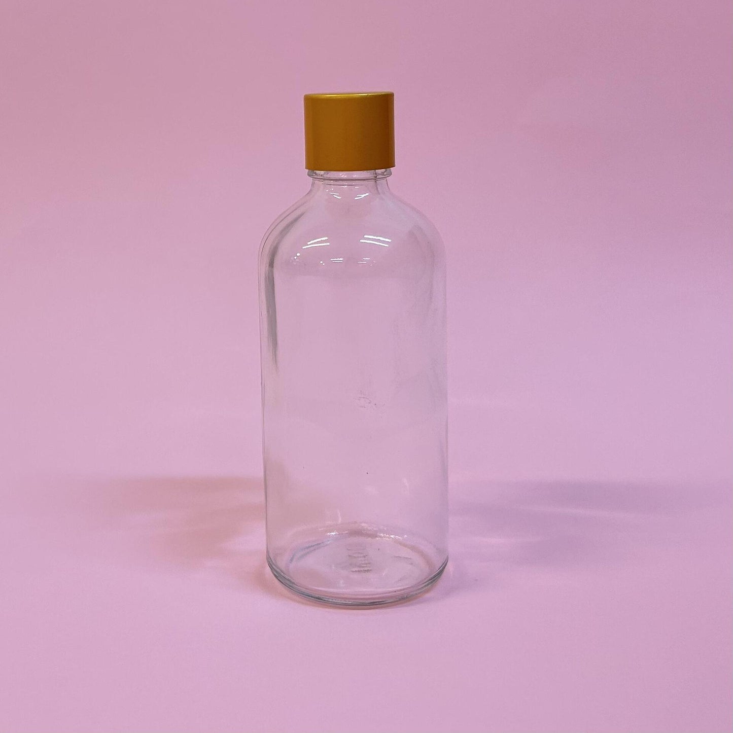 Стъклена прозрачна бутилка със златна капачка 100мл