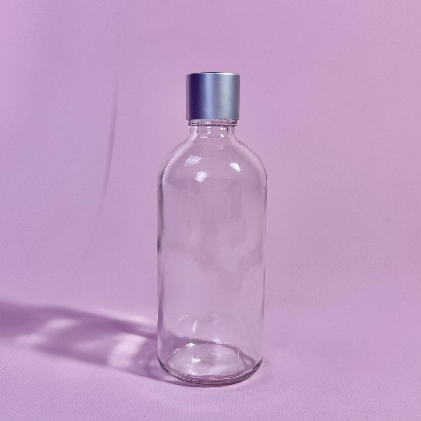 Стъклена прозрачна бутилка със сребърна капачка 100мл